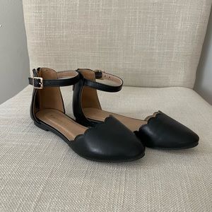 Scalloped black shoes with ankle belt